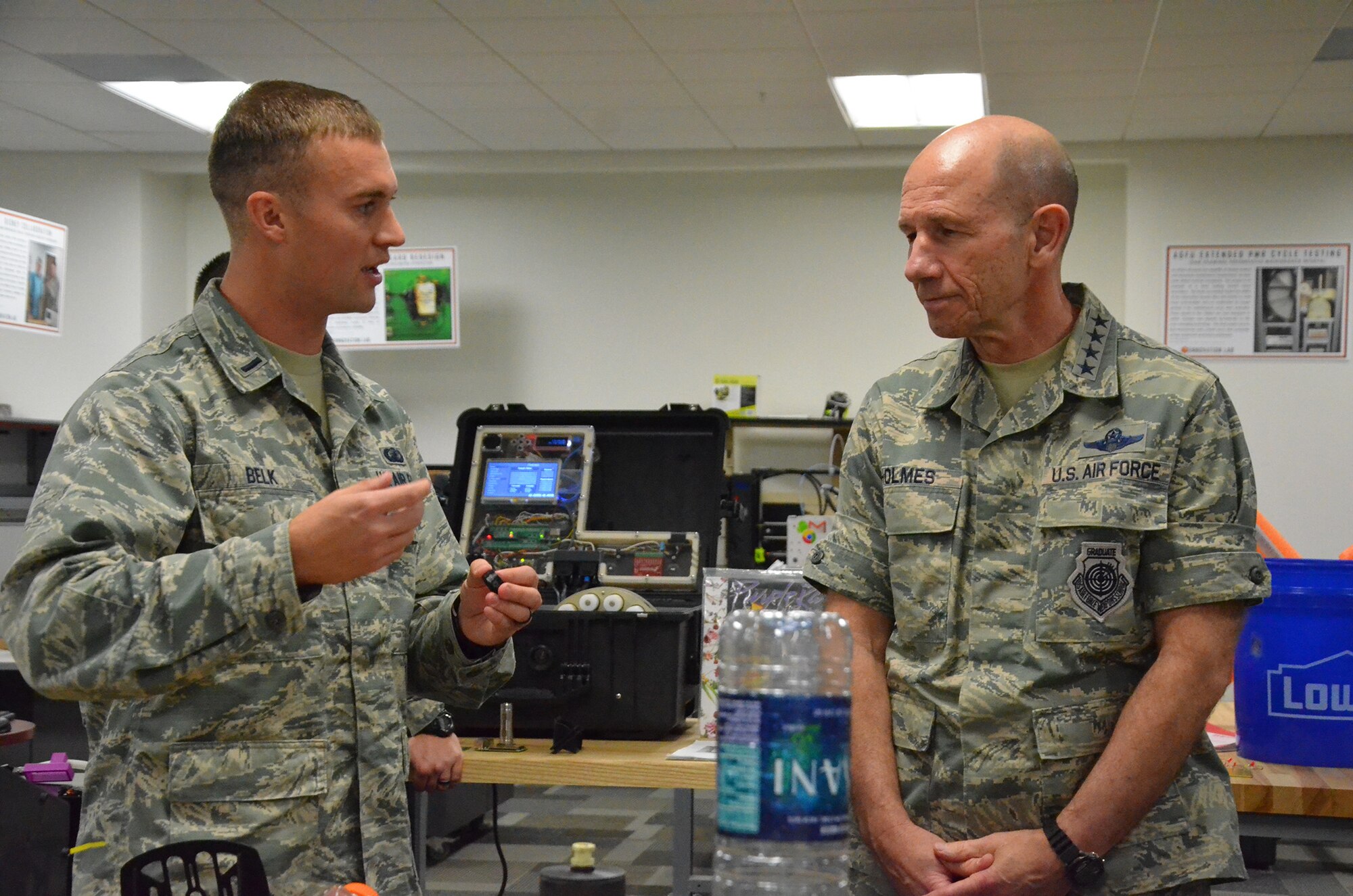 First Lt. Drew Belk, Innovation Lab chief at the Air Force Technical Applications Center, Patrick AFB, Fla., describes how his lab develops mesh bottle caps to increase the center's small volume collection capability to Gen. Mike Holmes, commander of Air Combat Command, during the general's visit Jan. 24, 2018.  AFTAC oversees the largest sensor network in the Air Force and is the sole nuclear treaty monitoring center in the Department of Defense.  (U.S. Air Force photo by Susan A. Romano)