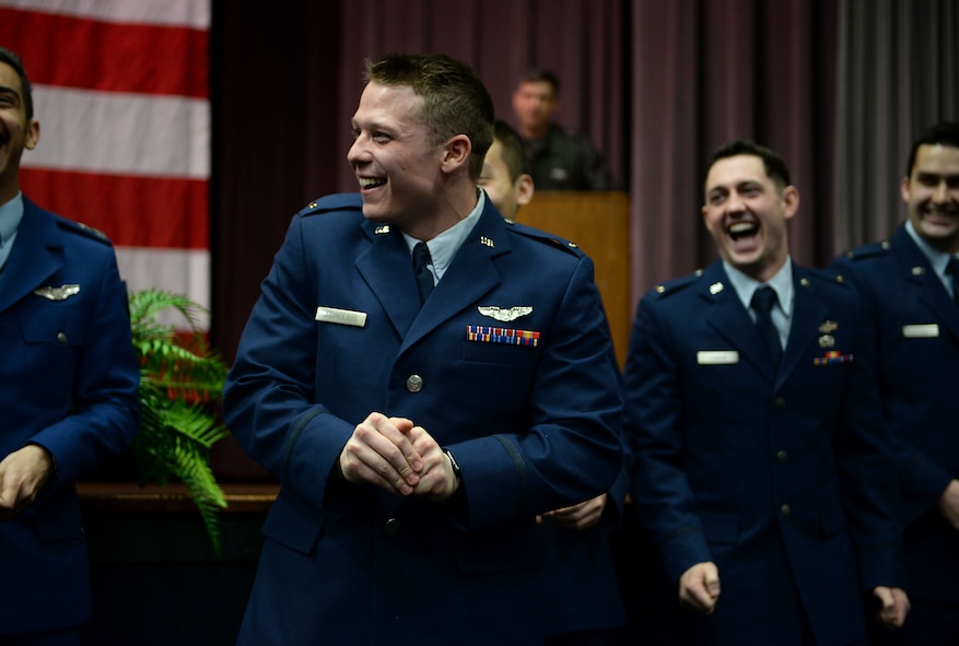 Second Lt. Denis Aurelious, 14th Student Squadron student pilot, attempts to break his first set of wings during Specialized Undergraduate Pilot Training Class 18-04’s graduation Jan, 19, 2018, on Columbus Air Force Base, Mississippi. At the end of every graduation the pilots break their first set of wings as tradition promoting good luck throughout their flying career. (U.S. Air Force photo by Airman 1st Class Keith Holcomb)