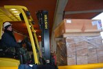 Camp Darby warehouse worker Denise Pazzaglia uses the fork lift to upload pallets of goods that will support a humanitarian relief shipment to Albania.  Excess vests, blankets, sleeping bags, sand bags and a water pump were among the more than 2200 pieces of equipment packed on 37 pallets shipped Jan. 17, 2018, from the Defense Security Cooperation Agency (DSCA) Humanitarian Assistance Program-Excess Property (HAP-EP) located in Camp Darby, Italy.