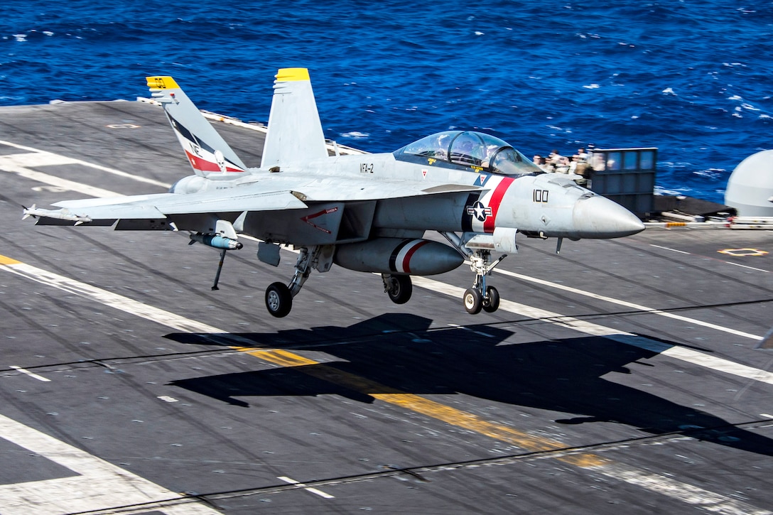 Navy Capt. Tom Barber, commander, Carrier Air Wing 2, and Cmdr. Jason Hutcherson, commander, Strike Fighter Squadron 2, complete their 1,000th carrier arrested landing.