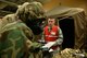 Tech. Sgt. Cody Robertson inspects Staff Sgt. Nikolas Souvannason and Staff Sgt. Chris Moore, all with the 55th Medical Group, read through their Airman Manuel to determine what type of explosive is in front of them during a training exercise inside the Martin Bomber building on Offutt AFB, Neb., Jan 18.