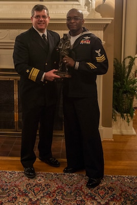 Commander, Navy Reserve Forces Command, Rear Adm. Thomas Luscher, left, presents Hospital Corpsman 1st Class Cedrick Jenkins, assigned to Commander, 4th Marine Division, Marine Forces Reserve, with a Lone Sailor Award  following his selection as Fiscal Year 2017 Navy Reserve Full Time Support Shore Sailor of Year (SOY). Jenkins will go on to compete for the title of 2017 Vice Chief of Naval Operations (Naval Shore Activities) SOY. (U.S. Navy photo by Mass Communication Specialist 2nd Class Sean Rinner)