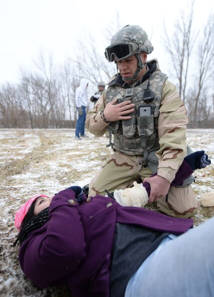 Tech. Sgt. Johann Gonzalez, 55th Security Forces Squadron training instructor, performs self-aid buddy care on an individual during an Operational Readiness Exercise at Offutt Air Force Base, Neb., Jan. 23.