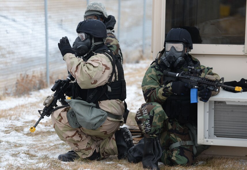 Members of the 55th Security Forces Squadron secure the perimeter during a simulated attack during an Operational Readiness Exercise at Offutt Air Force Base, Neb., Jan. 23,