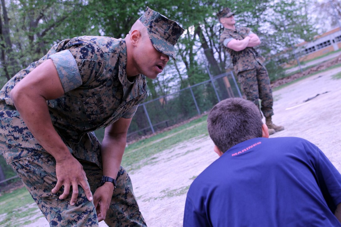 U.S. Marine Private First Class Jacob P. Sullivan encourages a poolee during Recruiting Sub Station Ann Arbor's family night. Sullivan lost over 170 pounds in 16 months to allow himself the chance to earn the title U.S. Marine. Sullivan's hometown is Sacramento, California but he flew halfway across the country to Ann Arbor, Michigan to attend recruit training before his 29th birthday. (U.S. Marine Corps photo by Sgt. J. R. Heins/ Released)