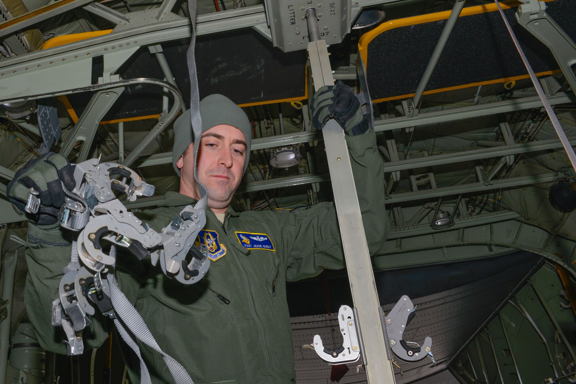 Tech. Sgt. Jesse Guest, a reserve aeromedical technician with the 934th Aeromedical Evacuation Squadron, configures the inside of a C-130 to accept patient litters prior to a trainer mission at the Minneapolis-St. Paul Air Reserve Station, Minn., on Jan. 8, 2018. Guest is also an emergency medical technician for the St. Paul fire department. (U.S. Air Force photo by Master Sgt. Eric Amidon)