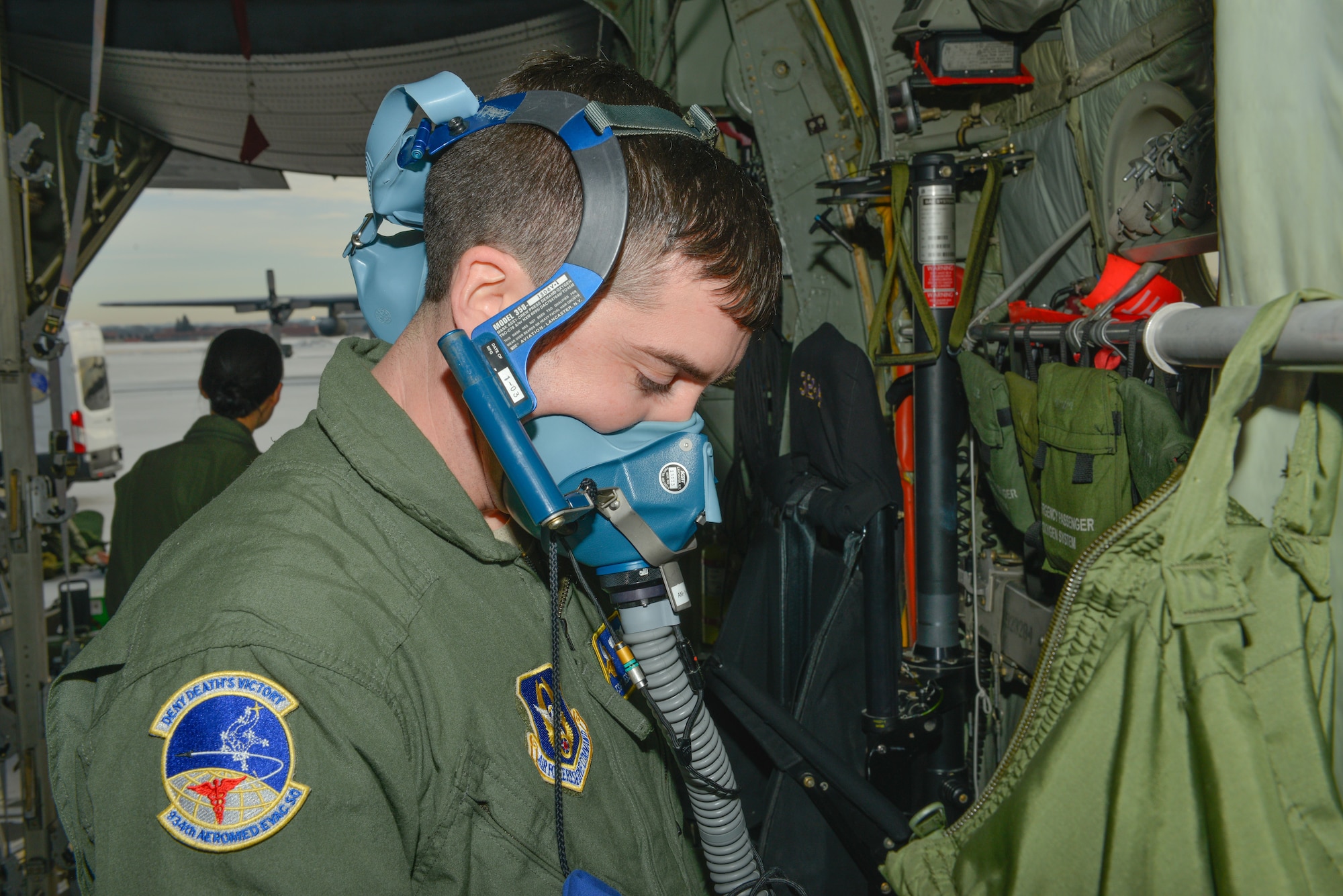 Tech. Sgt. Jesse Guest, a reserve aeromedical technician with the 934th Aeromedical Evacuation Squadron, tests his self-contained breathing equipment prior to participating in a trainer mission  at the Minneapolis-St. Paul Air Reserve Station, Minn., on Jan. 8, 2018. The trainer missions provide training in aeromedical evacuation procedures and combat medical support. (U.S. Air Force photo by Master Sgt. Eric Amidon)