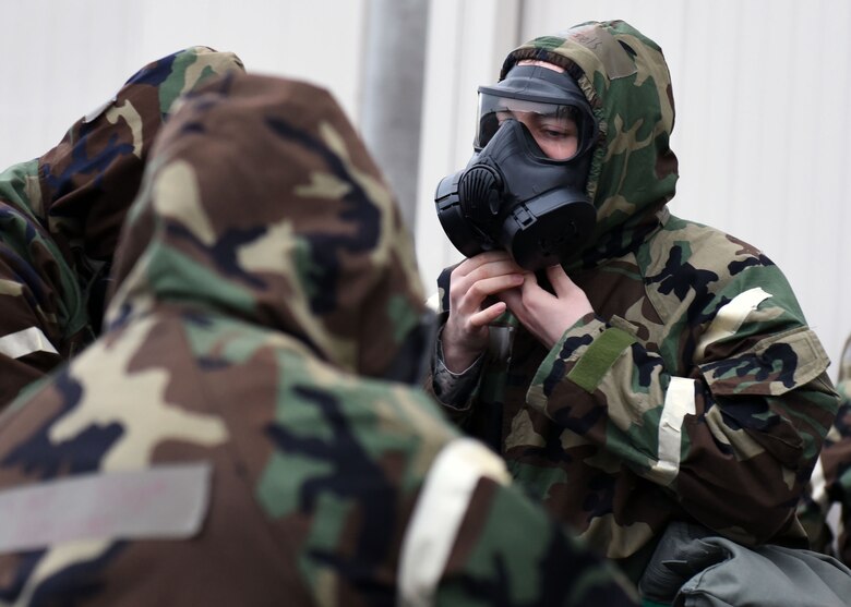 Airmen assigned to the 62nd Airlift Wing and 627th Air Base Group don mission oriented protective posture gear during Exercise Winterhook, Jan. 25, 2018 on the McChord Field flightline at Joint Base Lewis-McChord. Throughout the exercise, Airmen demonstrated proficiency not only in utilizing MOPP gear effectively at all five levels, but in carrying out job-related tasks while wearing the gear. (U.S. Air Force photo by Staff Sgt. Whitney Taylor)