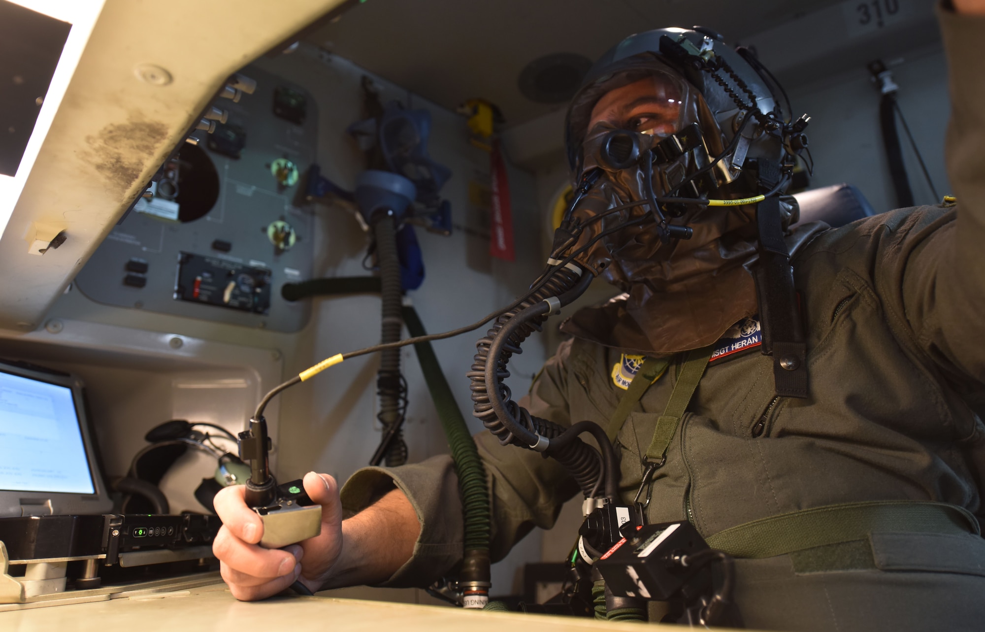 Master Sgt. Heran Pandya, 62nd Operations Support Squadron crew chief, checks his communication with the pilots of a C-17 Globemaster III during Exercise Winterhook at Joint Base Lewis-McChord, Wash., Jan. 25, 2018. Team McChord participated in the exercise from Jan. 22 to 26 to practice their ability to deploy and operate during a chemical, biological, radiological or nuclear threat. (U.S. Air Force photo by Senior Airman Tryphena Mayhugh)