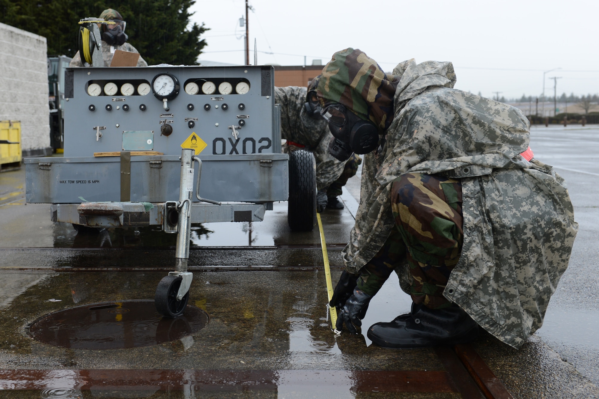 Airman 1st Class Conner Adams and Airman 1st Class Andrew Amezquita, 62nd Aerial Port Squadron air transportation, measure cargo for upload during Exercise Winterhook, Jan 23, 2018, at the McChord Field flightline, Joint Base Lewis-McChord, Wash. Cargo is checked for correct documentation, weights, and dimensions before being loaded onto an aircraft. (U.S. Air Force photo by Airman 1st Class Sara Hoerichs)