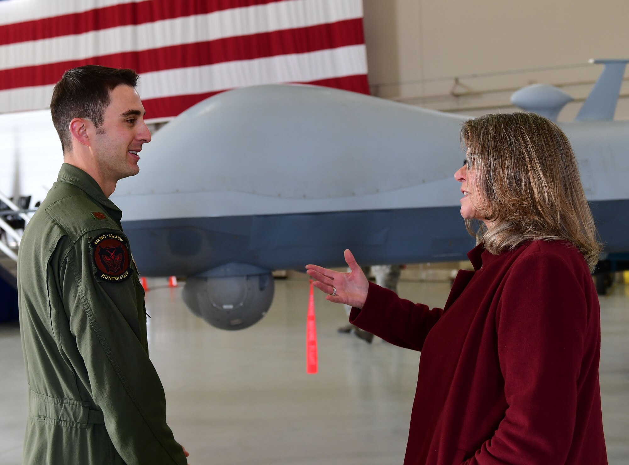 Ms. Jonna Doolittle Hoppes, executive director of the Doolittle Foundation and granddaughter of Gen. James “Jimmy” Doolittle, speaks to Maj. Matthew, 432nd Wing pilot, Jan. 18, 2018, at Creech Air Force Base, Nev. Ms. Doolittle Hoppes toured the base with retired Lt. Gen. Christopher Miller, president of the Air Force Historical Foundation, before presenting the General James H. “Jimmy” Doolittle award to the 432nd Wing/432nd Air Expeditionary Wing. (U.S. Air Force photo/Senior Airman Christian Clausen)