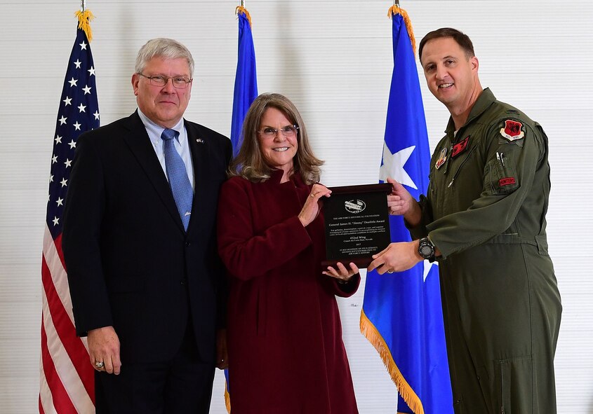 Ms. Jonna Doolittle Hoppes, executive director of the Doolittle Foundation and granddaughter of Gen. James “Jimmy” Doolittle, and retired Lt. Gen. Christopher Miller, president of the Air Force Historical Foundation, present the General James H. “Jimmy” Doolittle award to Col. Julian Cheater on behalf of the 432nd Wing/432nd Air Expeditionary Wing Jan. 18, 2018, at Creech Air Force Base, Nev. The General James H. “Jimmy” Doolittle award is presented to units who display gallantry, determination, espirit de corps and superior management of joint operations in accomplishing its mission under difficult and hazardous conditions in multiple conflicts. (U.S. Air Force photo/Senior Airman Christian Clausen)