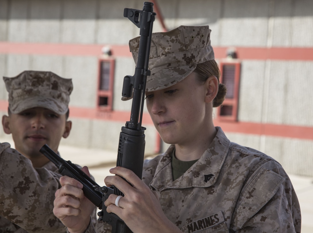 Cpl. Madeline Engle, a radio operator with Task Force Al-Taqaddum 18.1 Rotation 6, assembles an AK-47 assault rifle during a foreign weapons demonstration at Marine Corps Base Camp Pendleton, California, Jan. 16, 2018.
