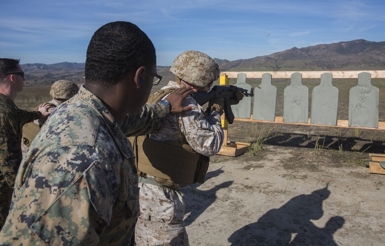 Tactics instructors with the I Marine Expeditionary Force Advisor Training Branch closely supervise the use of AK-47 assault rifles as part of a foreign weapons demonstration for Marines with Task Force Al-Taqaddum 18.1 Rotation 6 at Marine Corps Base Camp Pendleton, California, Jan. 16, 2018.