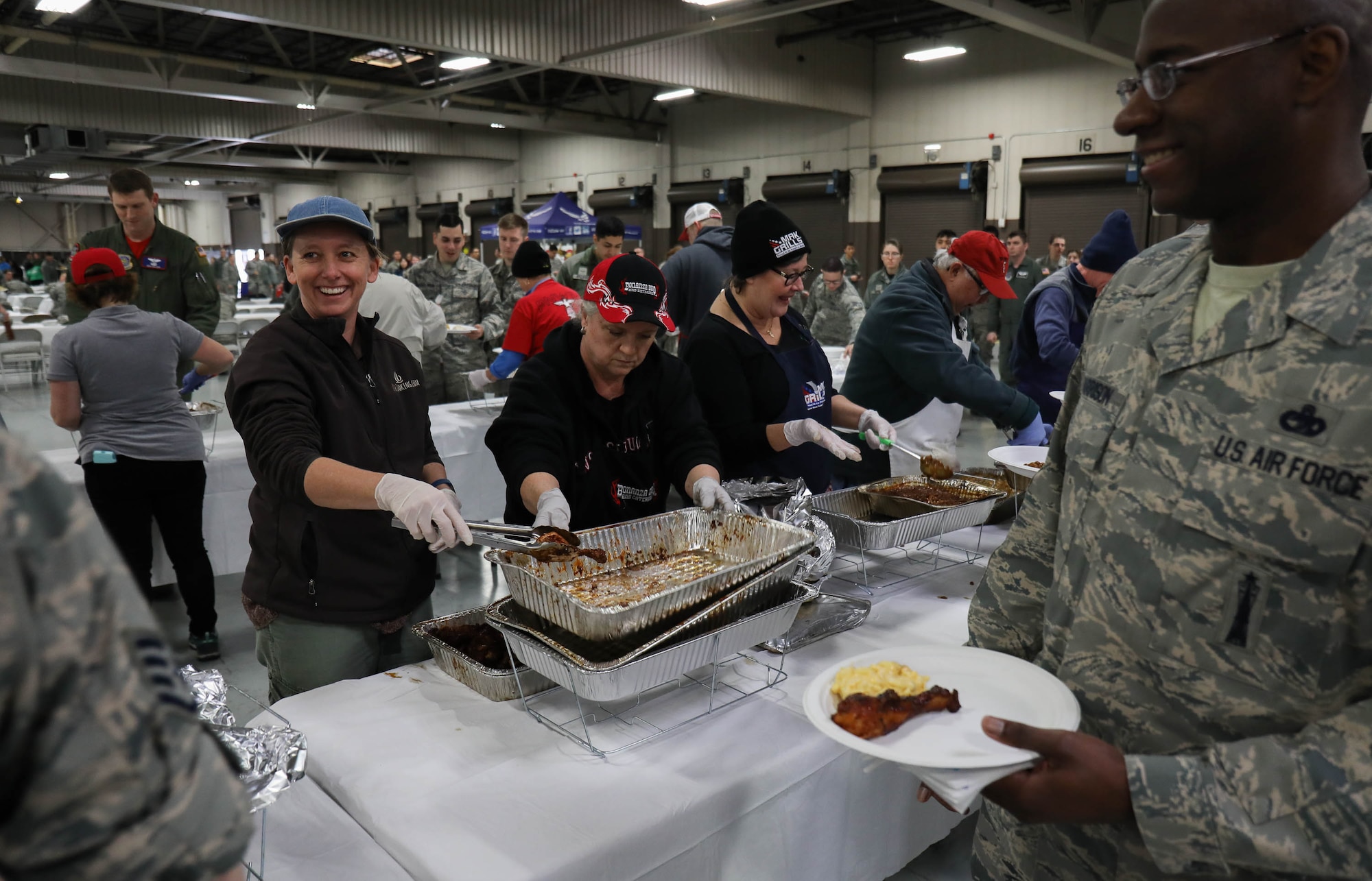 Airmen of the 62nd and 446th Airlift Wings participate in Diversity Day, an event that celebrated cultural differences between service members Jan. 19, 2018, on Joint Base Lewis-McChord. Barbecue prepared by Washington State pitmasters, paired with members of both wings, was served free of charge.