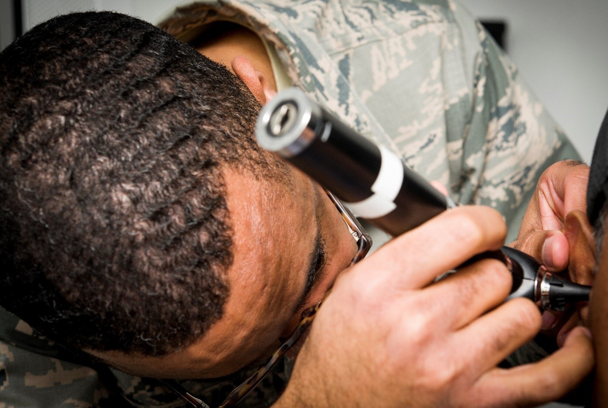 Maj. Ramone Williams, audiology element chief, 59th Medical Wing, Joint Base San Antonio-Lackland, Texas, examines a patient’s ear canal during a screening, Jan. 24, 2018. The audiology clinic is the largest of its kind Air Force-wide and supports over 200,000 retirees, dependents, and military personnel. (U.S. Air Force photo by Senior Airman Keifer Bowes)