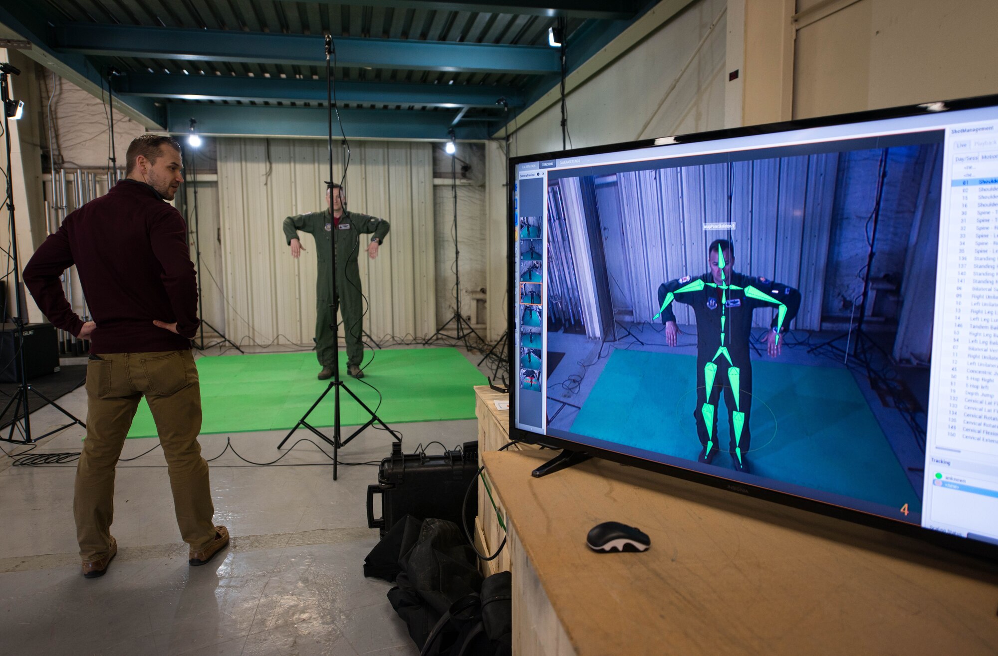 Joel Hungate, Dynamic Athletic Research Institute program manager, analyzes the movements of Maj. Wyckliffe Furcron, 69th Fighter Squadron F-16 pilot, during a DARI assessment at Luke Air Force Base, Ariz., Jan. 26, 2018. The assessment was conducted using the DARI marker-less motion analytics machine, an eight camera system designed to pinpoint weak muscle groups and predict which areas of the body are most prone to injury. (U.S. Air Force photo by Airman 1st Class Alexander Cook)