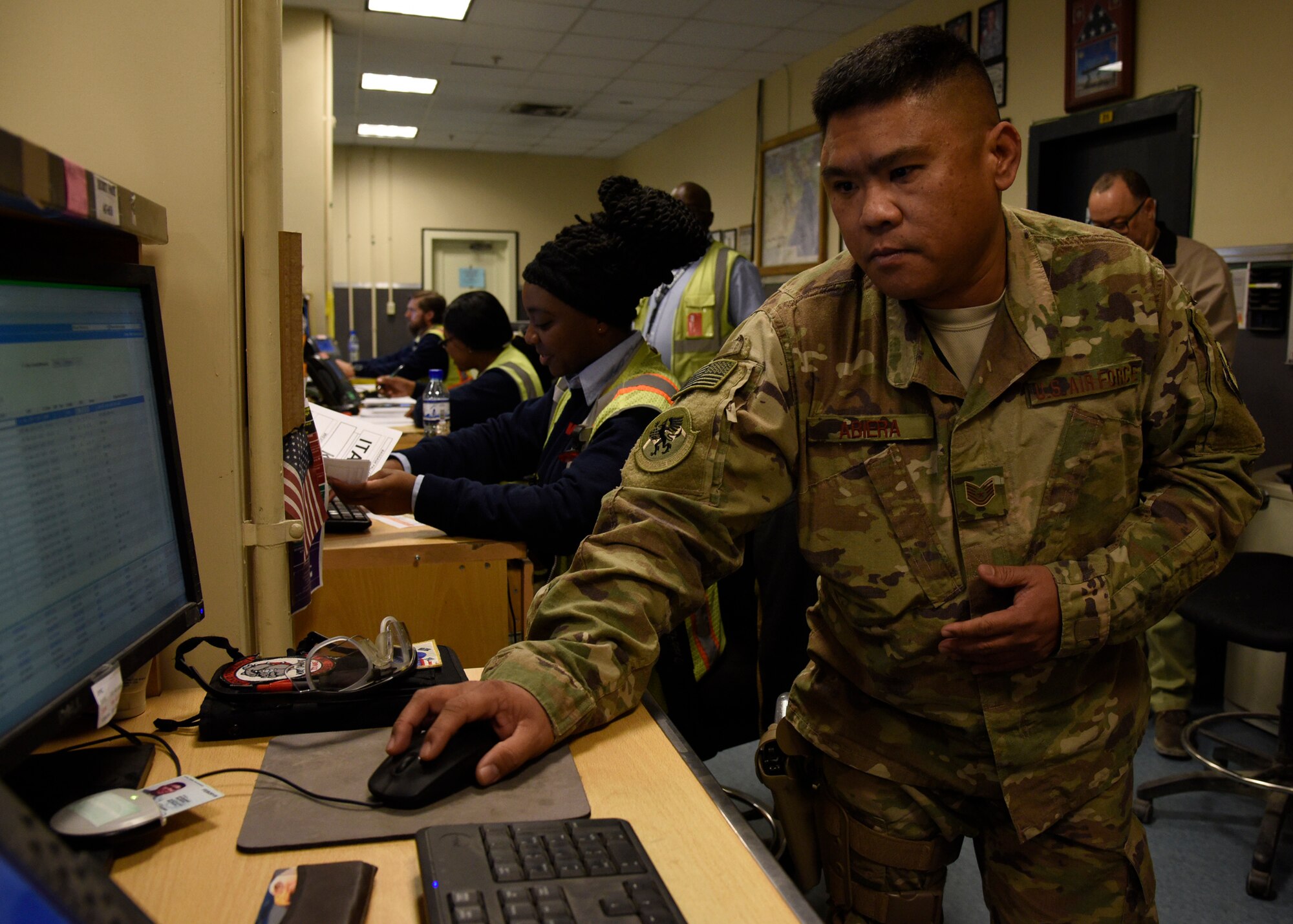 Tech. Sgt. Timothy Abiera, 455th Expeditionary Logistics Readiness Squadron contracting officer representative, demonstrates how the new process of checking in passengers at the passenger terminal will work Jan. 19, 2018 at Bagram Airfield, Afghanistan.
