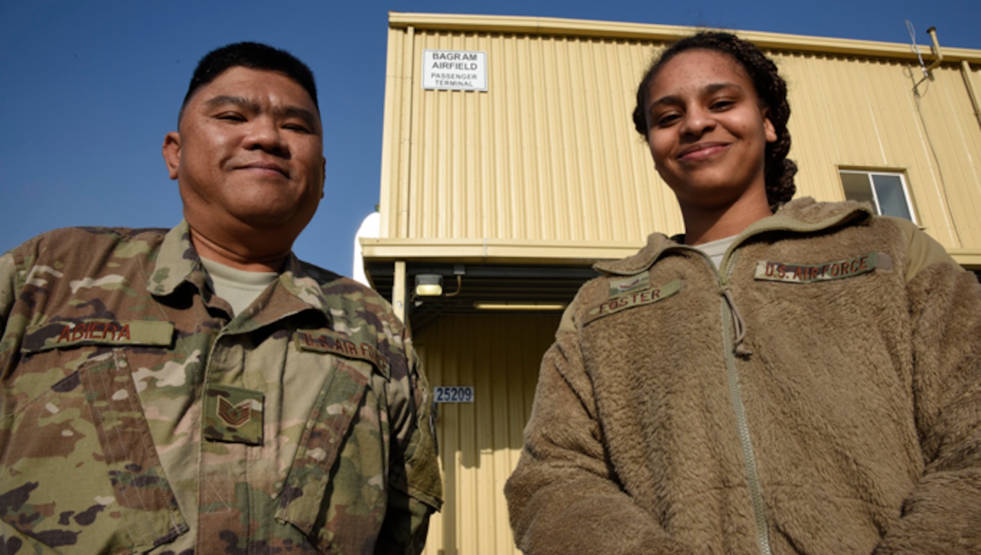 Tech. Sgt. Timothy Abiera, 455th Expeditionary Logistics Readiness Squadron contracting officer representative, and Senior Airman Najse Foster, 455th Expeditionary Communications Squadron knowledge manager, pose for a photo Jan. 19, 2018 at Bagram Airfield, Afghanistan.