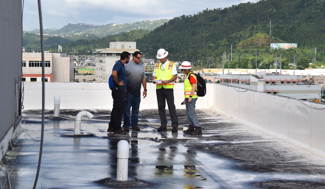 Members of the U.S. Army Corps of Engineers' Critical Public Facilities team in Puerto Rico meet with contractors who are doing temporary roofing repairs to critical facilities throughout the island. The Critical Public Facilities team is focused on making temporary roof repairs to buildings like police stations, fire stations, and hospitals to get these services back online faster post-Hurricane Maria.