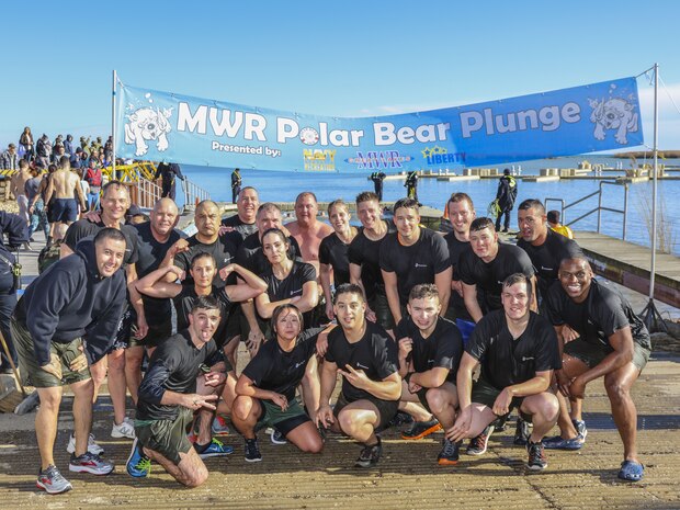 Marines, civilians and friends in the 9th Marine Corps District family pose for photo during the MWR Polar Bear Plunge at Naval Station Great Lakes, Ill., Jan. 27. Around the world, thrill seekers participate in the Polar Bear Plunge, which consist of jumping into freezing water. (Photo by U.S. Marine Cpl. Quavaungh Pointer)