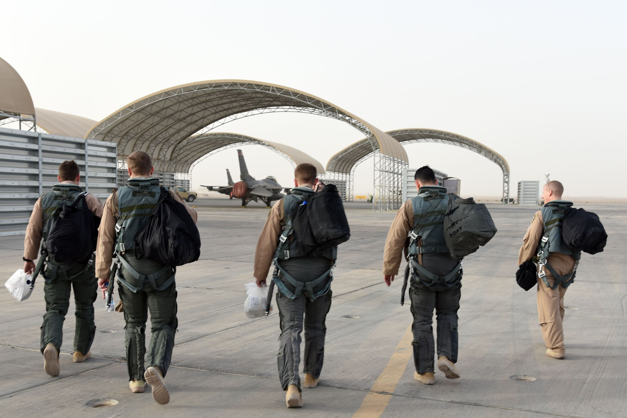 100th Expeditionary Fighter Squadron pilots walk to their F-16 Fight Falcons before returning home at an undisclosed location in Southwest Asia, Jan. 20, 2018. These pilots contributed to dropping 105 bombs in the fight against ISIS. (U.S. Air Force photo by Staff Sgt. Joshua Edwards/Released)