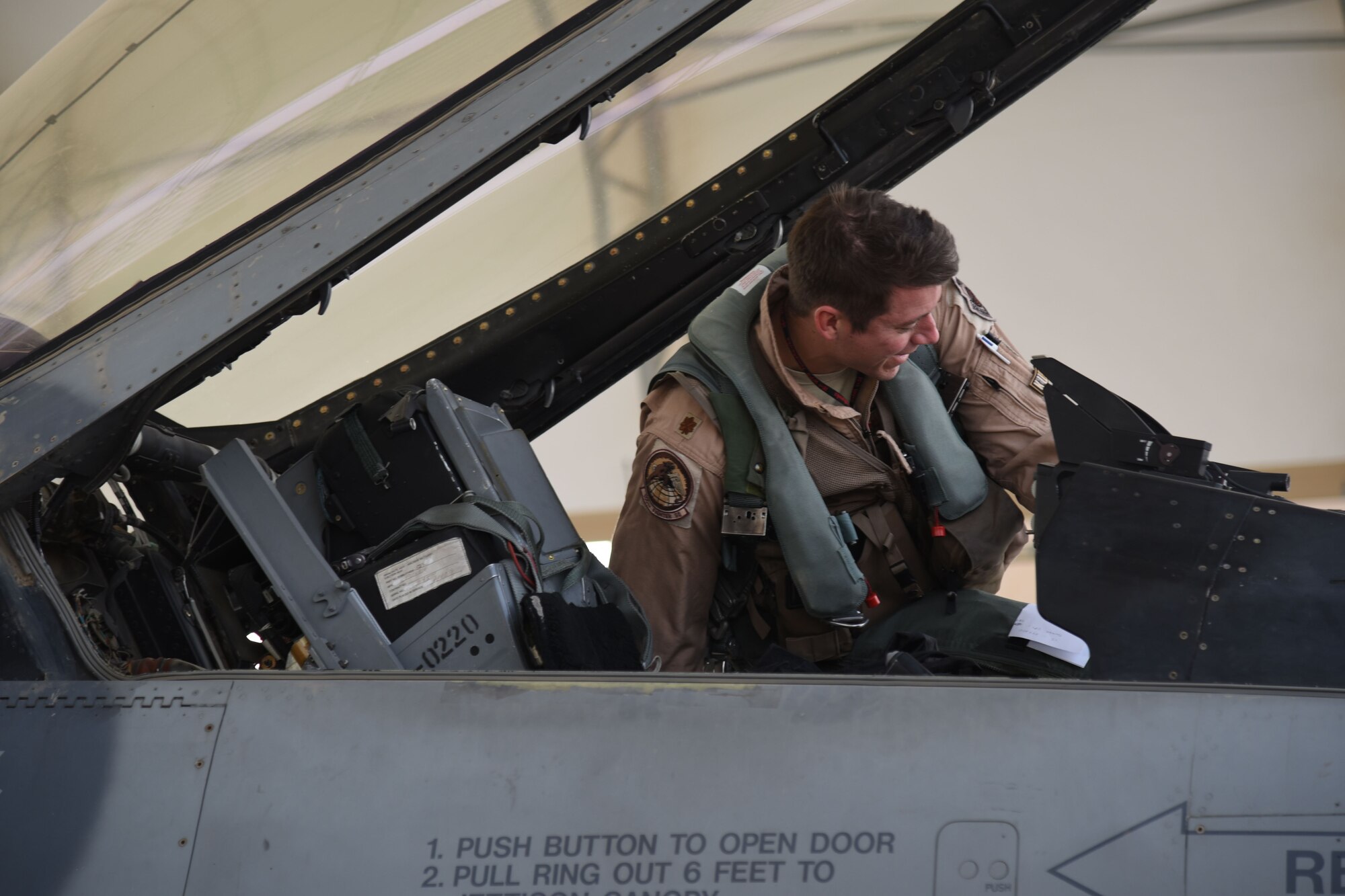 A 100th Expeditionary Fighter Squadron pilot checks his cockpit before a flight at an undisclosed location in Southwest Asia, Jan. 20, 2018. This was one of the final steps for the pilot before returning home from his deployment. (U.S. Air Force photo by Staff Sgt. Joshua Edwards/Released)