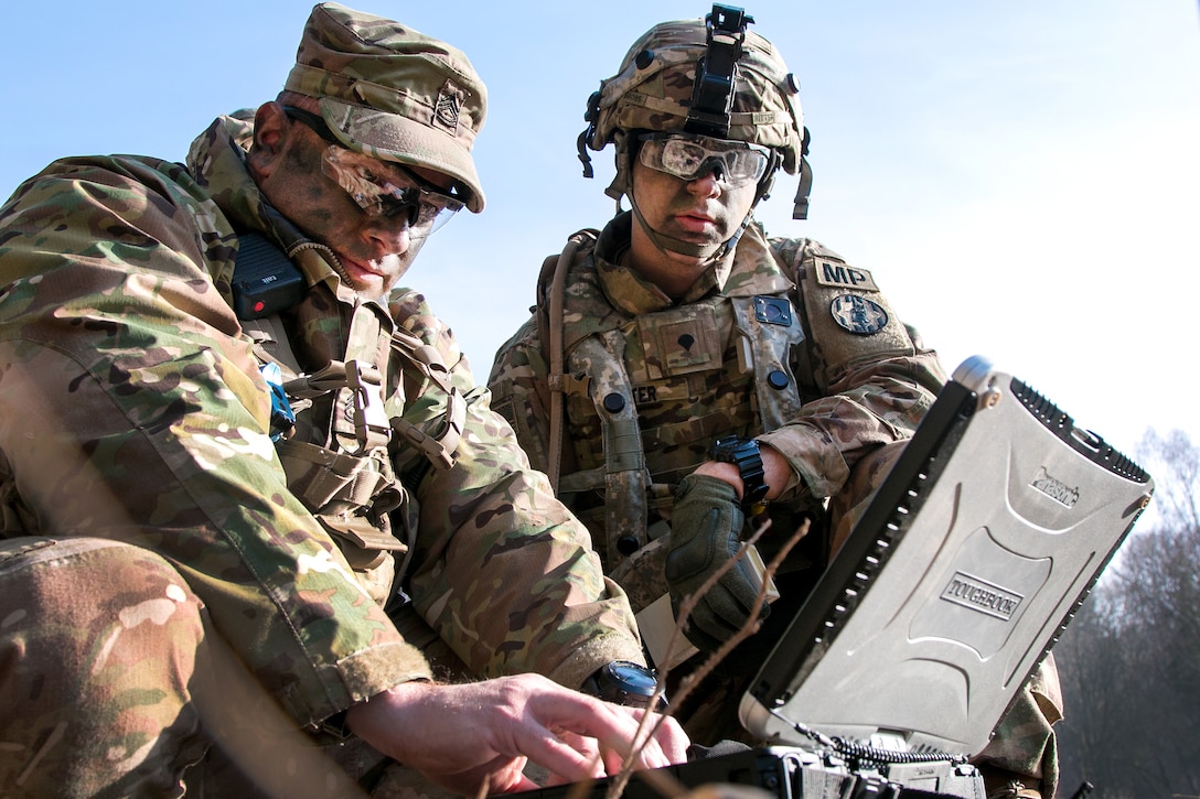 Army Sgt. 1st Class Joseph Rombold, left, shows Spc. William Ritter how to properly set up the the RQ-11 Raven, a small unmanned aerial system during Allied Spirit VIII at Hohenfels Training Area, Germany.
