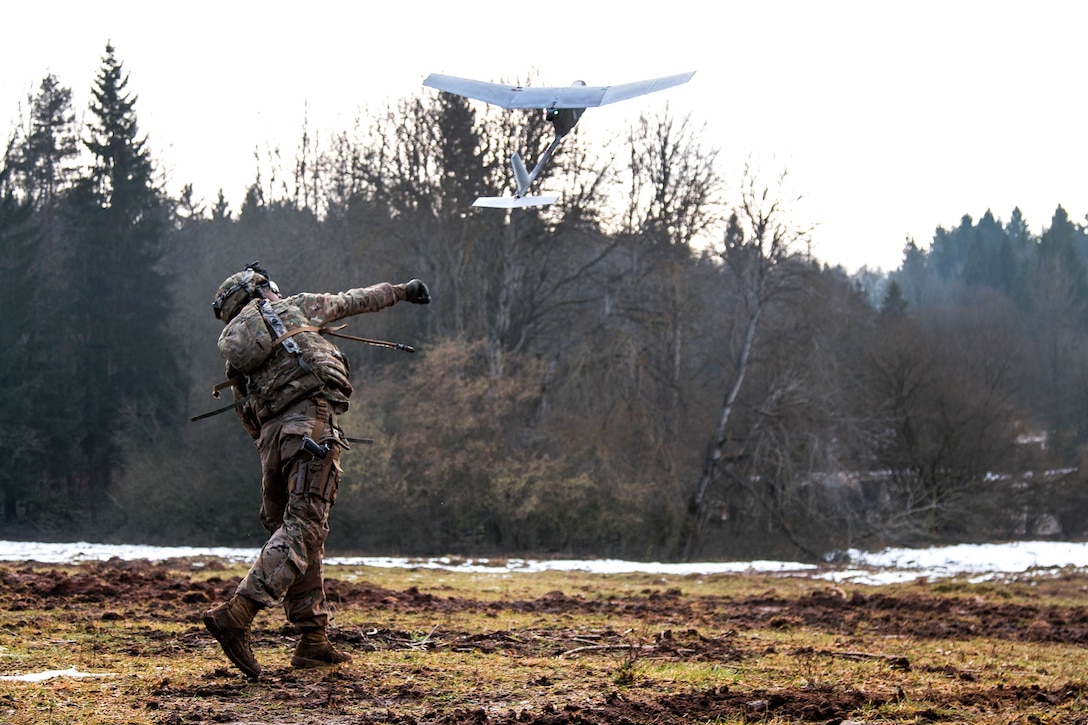 Army Spc. William Ritter launches an RQ-11 Raven, small unmanned aerial system, into the air during Allied Spirit VIII at Hohenfels Training Area, Germany.