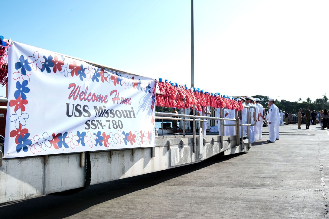 Sailors await the arrival the fast-attack submarine USS Missouri to welcome them to their new home port at Pearl Harbor, Hawaii.