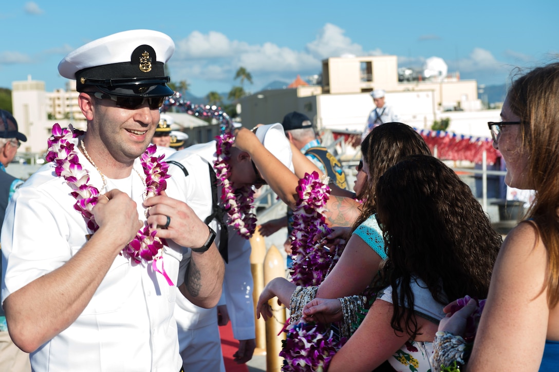 Sailors aboard the USS Missouri are greeted by family and friends following the change of home port.