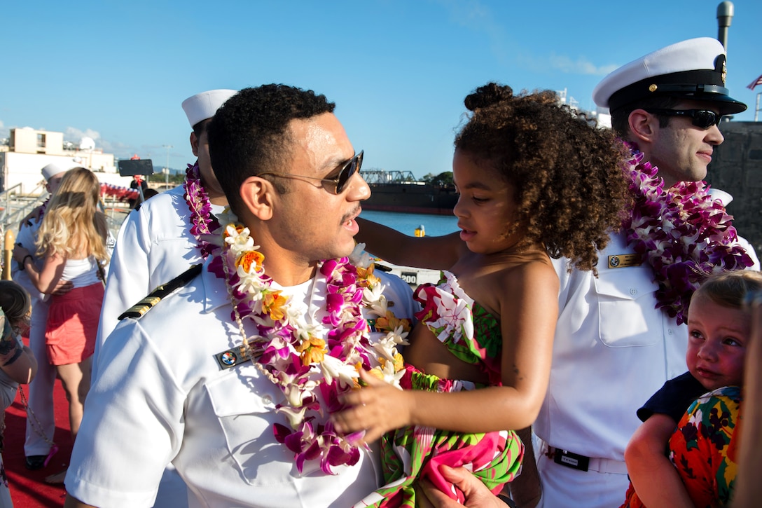 Navy Lt. Freeman Davenport is greeted by his daughter following the change of home port of the fast-attack submarine USS Missouri.