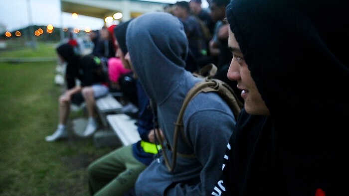 Marines and Sailors with 3rd Marine Logistics Group gather to participate in the Kinser Challenge at Roberts Field on Camp Kinser, Okinawa, Japan Jan. 26, 2018.  The Kinser Challenge is an event organized by the 3rd MLG chaplain’s office and hosted by Combat Logistics Regiment 35, to promote camaraderie, physical exercise, mental aptitude and spiritual wellness. (U.S. Marine Corps photo by Cpl. Joshua Pinkney)