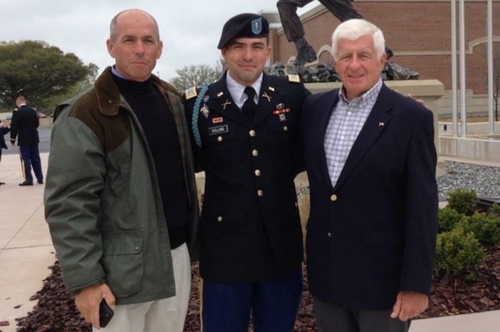 Three men pose for a picture.