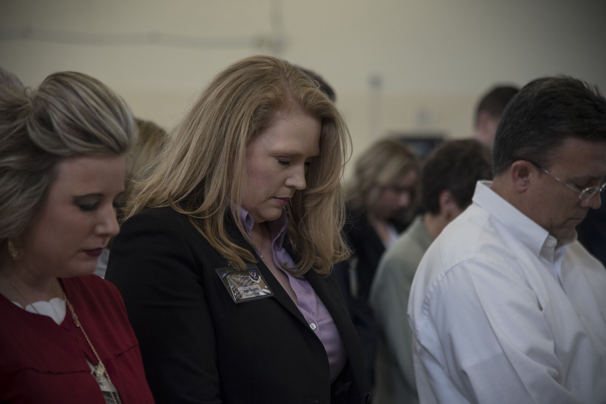 Paige Dukes, incoming 23d Wing honorary commander, bows her head for prayer during an Honorary Commander Change of Command ceremony at Moody Air Force Base, Ga., Jan. 26, 2018. The Honorary Commander Program allows local community leaders to gain awareness of Moody’s mission through official and social functions. (U.S. Air Force photo by Staff Sgt. Olivia Dominique)