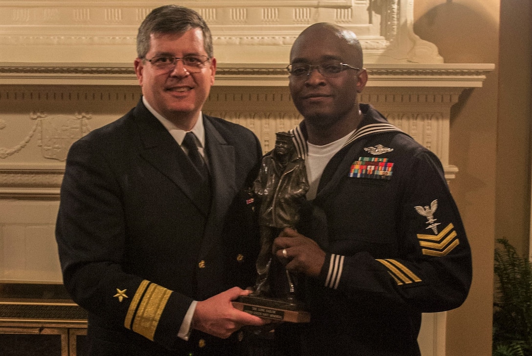 Commander, Navy Reserve Forces Command, Rear Adm. Thomas Luscher, left, presents Hospital Corpsman 1st Class Cedrick Jenkins, assigned to Commander, 4th Marine Division, Marine Forces Reserve, with a Lone Sailor Award  following his selection as Fiscal Year 2017 Navy Reserve Full Time Support Shore Sailor of Year. Jenkins will go on to compete for the title of 2017 Vice Chief of Naval Operations (Naval Shore Activities) SOY. (U.S. Navy photo by Mass Communication Specialist 2nd Class Sean Rinner)