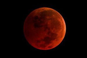 A photo of an orange moon.