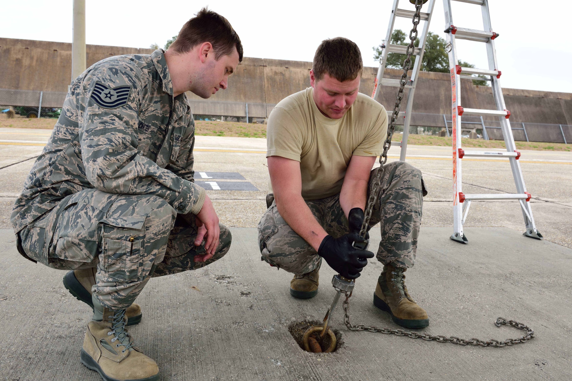 Tech. Sgt. Seth Johnson (right), 803rd Aircraft Maintenance Squadron dedicated crew chief, trains Tech. Sgt. Steven Carter, 803rd AMXS instrument flight control systems technician, how to moor a C-130J Super Hercules aircraft to the flight line to protect it from high winds Jan. 26, 2018, at Keesler Air Force Base, Mississippi. Crew chiefs are responsible for performing numerous checks, tests and maintenance on aircraft to make sure the Air Force fleet is fit for flight. (U.S. Air Force photo by Tech. Sgt. Ryan Labadens)