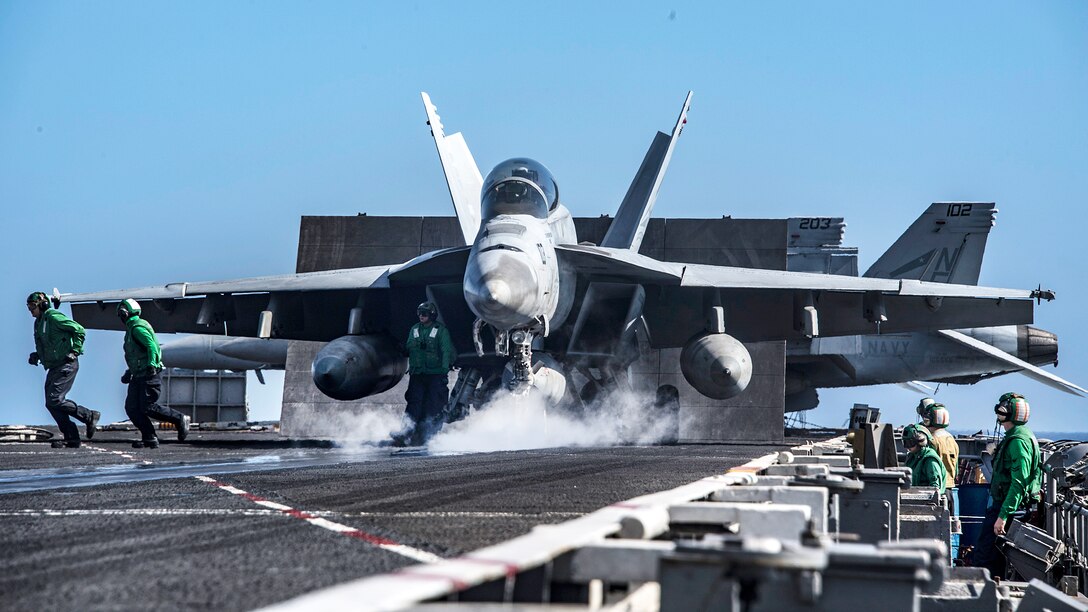A military aircraft prepares to launch from the flight deck of the USS Carl Vinson.