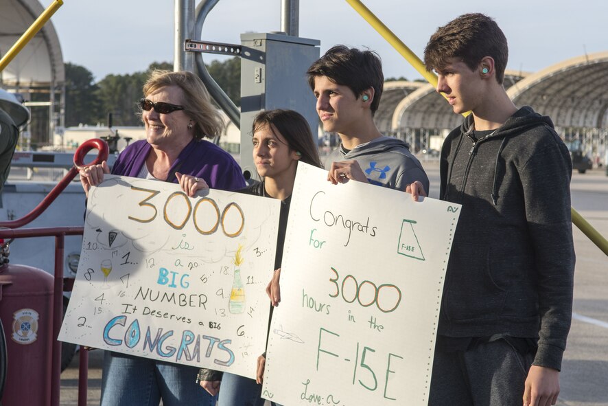he family of Lt. Col. Eric Ostendorf, 307th Fighter Squadron assistant director of operations, holds signs congratulating him on reaching 3,000 flying hours, Jan. 26, 2018, at Seymour Johnson Air Force Base, North Carolina.