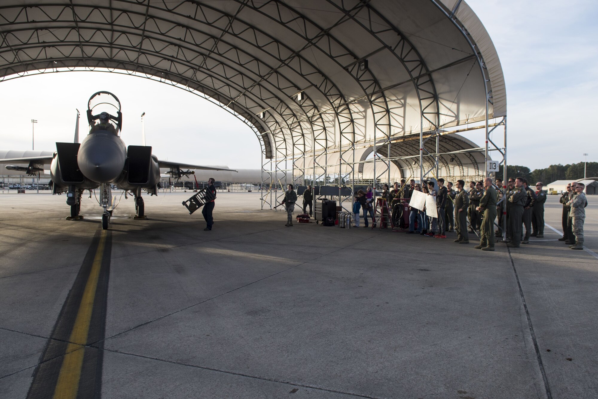 Family and friends of Lt. Col. Eric Ostendorf, 307th Fighter Squadron assistant director of operations, wait for him to exit an F-15E Strike Eagle, Jan. 26, 2018, at Seymour Johnson Air Force Base, North Carolina.