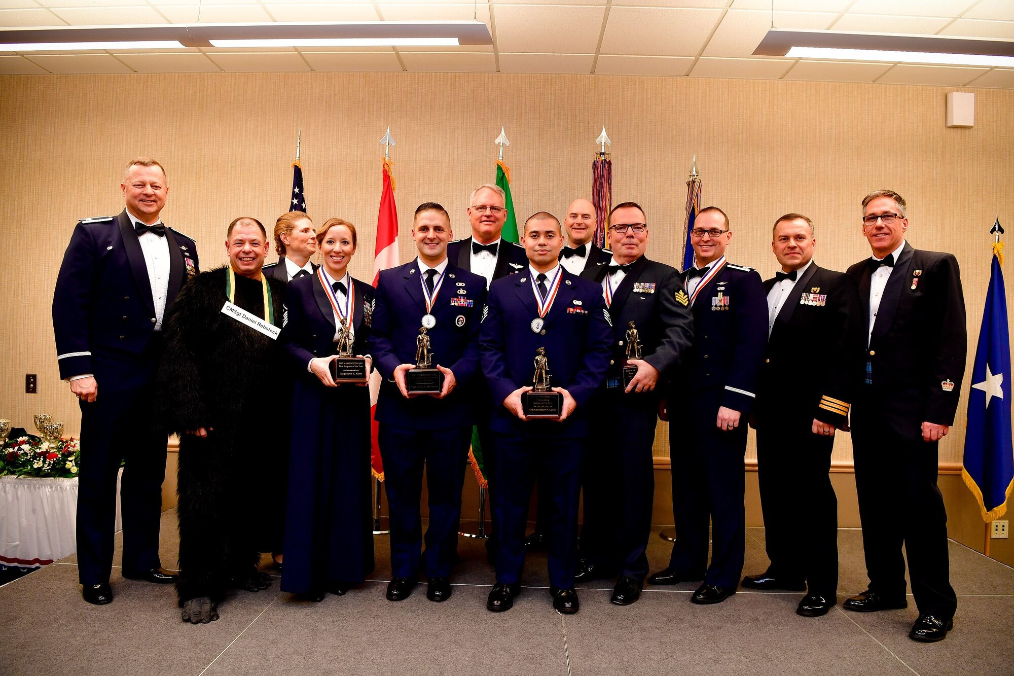 Annual award winners from the Western Air Defense Sector pose for a picture during the Washington Air National Guard's 9th Annual Awards Banquet held at the American Lake Conference Center on Joint Base Lewis-McChord, Washington, Jan. 27, 2018.  Pictured from left are: Col. Gregor Leist, WADS commander, Chief Master Sgt. Daniel Rebstock, WADS senior enlisted advisor, Col. Paige Abbott, 225th Support Squadron commander, Master Sgt. Dawn Kloos, 225th Air Defense Group first sergeant, Staff Sgt. Aaron DeCremer, 225th Air Defense Squadron, Col. William Krueger, 225th Air Defense Group commander, Staff Sgt. Christopher LaCour, 225th SS, Col. Brett Bosselmann, 225th ADS commander, Royal Canadian Air Force Sgt. Yves Truchon, 225th ADS and Canadian Detachment, Capt. Joseph Hale, 225th SS, RCAF Lt. Col. Matthew Wappler, Canadian Detachment commander, RCAF Warrant Officer Gilles Turgeon, Canadian Detachment unit warrant officer.  (U.S. Air National Guard Photo by Tech. Sgt. Timothy Chacon)