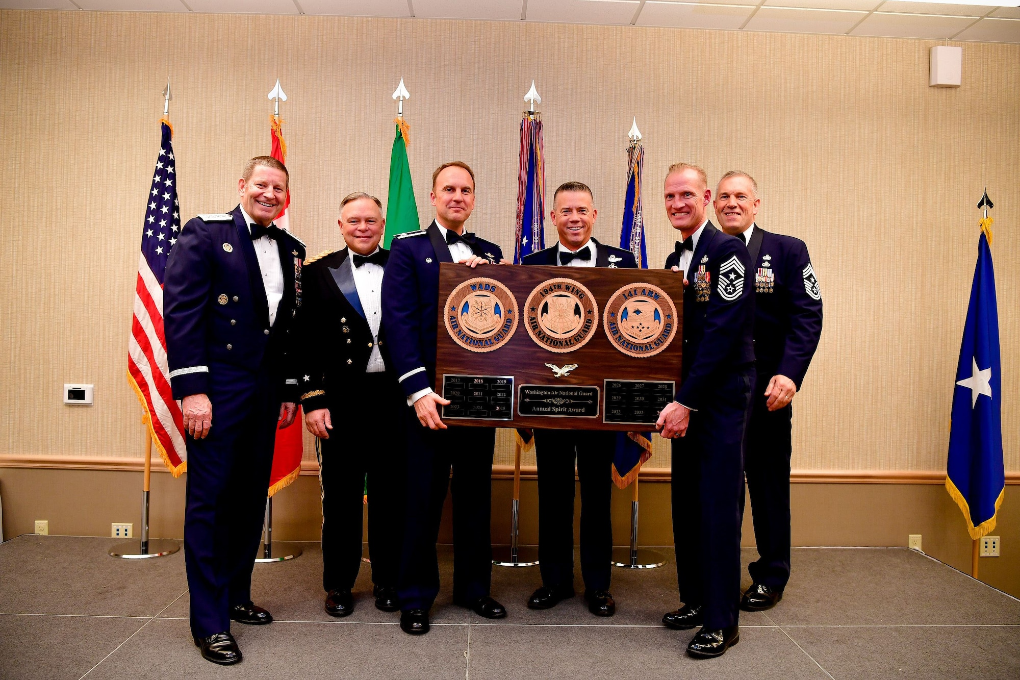 The 141st Air Refueling Wing commander, Col. Johan Deutscher, accepts the unit spirit award during the Washington Air National Guard's 9th Annual Awards Banquet held at the American Lake Conferenc Center on Joint Base Lewis-McChord, Washington, Jan. 27, 2018. Pictured from left are: Gen. Robin Rand, Air Force Global Strike Command and Air Forces Strategic-Air, U.S. Strategic Command commander; Maj. Gen. Bret Daugherty, Adjutant General of the Washington National Guard, Col. Johan Deutscher, 141st ARW commander, Brig. Gen. Jeremy Horn, commander of the Washington Air National Guard, Chief Master Sgt. Dave Bishop, 141st ARW command chief, and Chief Master Sgt. Max Tidwell, WA ANG command chief. (U.S. Air National Guard Photo by Tech. Sgt. Timothy Chacon)