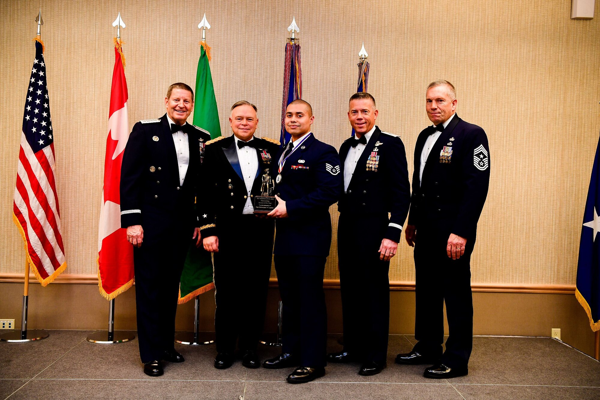 Staff Sgt. Christopher LaCour, a cyber systems operations journeyman with the 225th Support Squadron, Western Air Defense Sector, is presented with the Airman of the Year trophy at the Washington Air National Guard’s 9th Annual Awards Banquet held at the American Lake Conference Center on Joint Base Lewis-McChord, Washington, Jan. 27, 2018.  LaCour was awarded the trophy for his outstanding contributions to the Washington Air National Guard over the last year.  Pictured from left to right are: Gen. Robin Rand, Air Force Global Strike Command and Air Forces Strategic-Air, U.S. Strategic Command commander; Maj. Gen. Bret Daugherty, Adjutant General of the Washington National Guard, LaCour, Brig. Gen. Jeremy Horn, commander of the Washington Air National Guard, and Chief Master Sgt. Max Tidwell, WA ANG command chief. (U.S. Air National Guard photo by Tech. Sgt. Timothy Chacon)