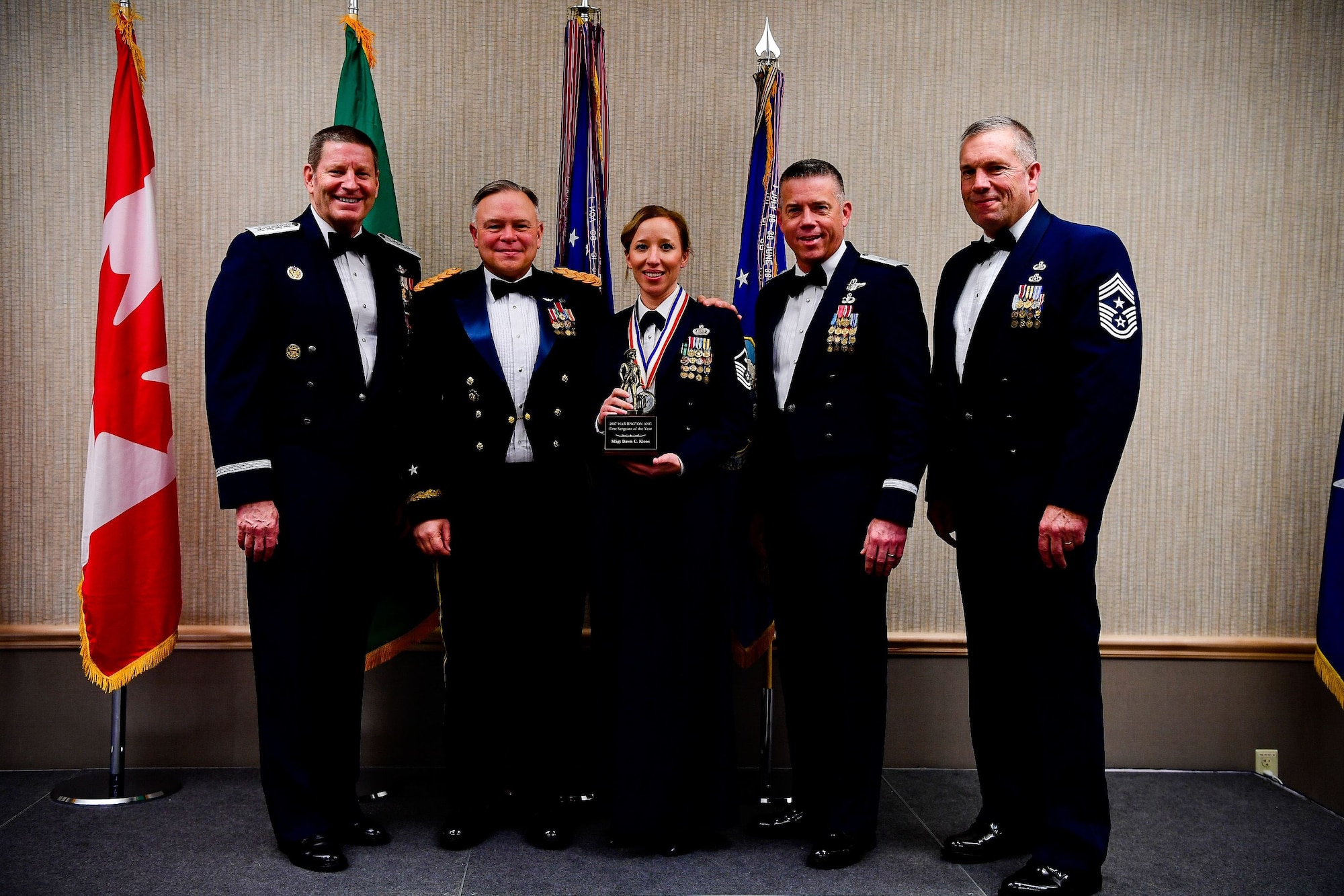 Master Sgt. Dawn Kloos, a first sergeant with the 225th Air Defense Group, Western Air Defense Sector, is presented with the First Sergeant of the Year trophy at the Washington Air National Guard’s 9th Annual Awards Banquet held at the American Lake Conference Center on Joint Base Lewis-McChord, Washington, Jan. 27, 2018. Kloos was awarded the trophy for his outstanding contributions to the Washington Air National Guard over the last year.  Pictured from left to right are: Gen. Robin Rand, Air Force Global Strike Command and Air Forces Strategic-Air, U.S. Strategic Command commander; Maj. Gen. Bret Daugherty, Adjutant General of the Washington National Guard, Kloos, Brig. Gen. Jeremy Horn, commander of the Washington Air National Guard, and Chief Master Sgt. Max Tidwell, WA ANG command chief. (U.S. Air National Guard photo by Tech. Sgt. Timothy Chacon)