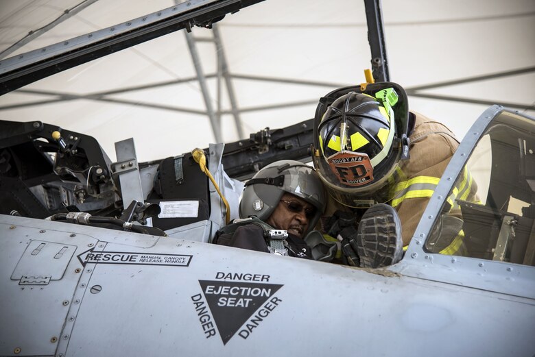 Airman 1st Class Orlando Chapman, 23d Civil Engineer Squadron (CES) firefighter, prepares to lift Charlie Johnson, 23d CES assistant fire chief of training, out of an A-10C Thunderbolt II, Jan. 24, 2018, at Moody Air Force Base, Ga. Firefighters from the 23d CES conducted A-10C Thunderbolt II extraction training to practice extinguishing an aircraft fire and quickly rescuing a pilot from an A-10. The 23d CES holds the extraction training twice annually and are evaluated on the amount of time it takes them to rescue a pilot from the cockpit. (U.S. Air Force photo by Airman Eugene Oliver)