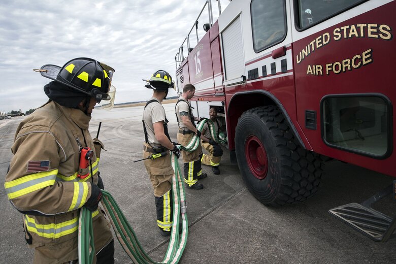 Firefighters from the 23d Civil Engineer Squadron (CES) roll up a hose, Jan. 24, 2018, at Moody Air Force Base, Ga. Firefighters from the 23d CES conducted A-10C Thunderbolt II extraction training to practice extinguishing an aircraft fire and quickly rescuing a pilot from an A-10. The 23d CES holds the extraction training twice annually and are evaluated on the amount of time it takes them to rescue a pilot from the cockpit. (U.S. Air Force photo by Airman Eugene Oliver)
