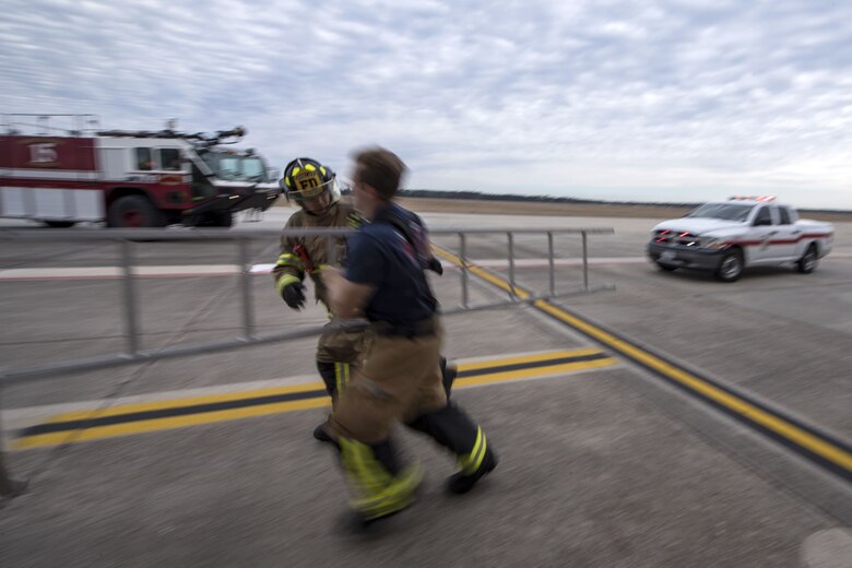 Firefighters from the 23d Civil Engineer Squadron (CES) carry a ladder during extraction training, Jan. 25, 2018, at Moody Air Force Base, Ga. Firefighters from the 23d CES conducted A-10C Thunderbolt II extraction training to practice extinguishing an aircraft fire and quickly rescuing a pilot from an A-10. The 23d CES holds the extraction training twice annually and are evaluated on the amount of time it takes them to rescue a pilot from the cockpit. (U.S. Air Force photo by Airman Eugene Oliver)