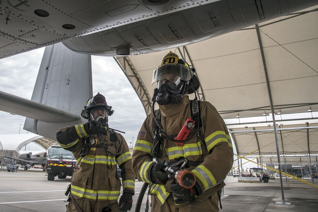 Firefighters from the 23d Civil Engineer Squadron (CES) inspect the wing of an A-10C Thunderbolt II, Jan.24, 2018, at Moody Air Force Base, Ga. Firefighters from the 23d CES conducted A-10C Thunderbolt II extraction training to practice extinguishing an aircraft fire and quickly rescuing a pilot from an A-10. The 23d CES holds the extraction training twice annually and are evaluated on the amount of time it takes them to rescue a pilot from the cockpit. (U.S. Air Force photo by Airman Eugene Oliver)
