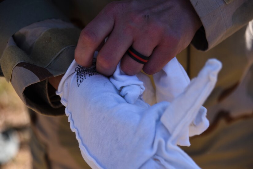 Airman puts on glove